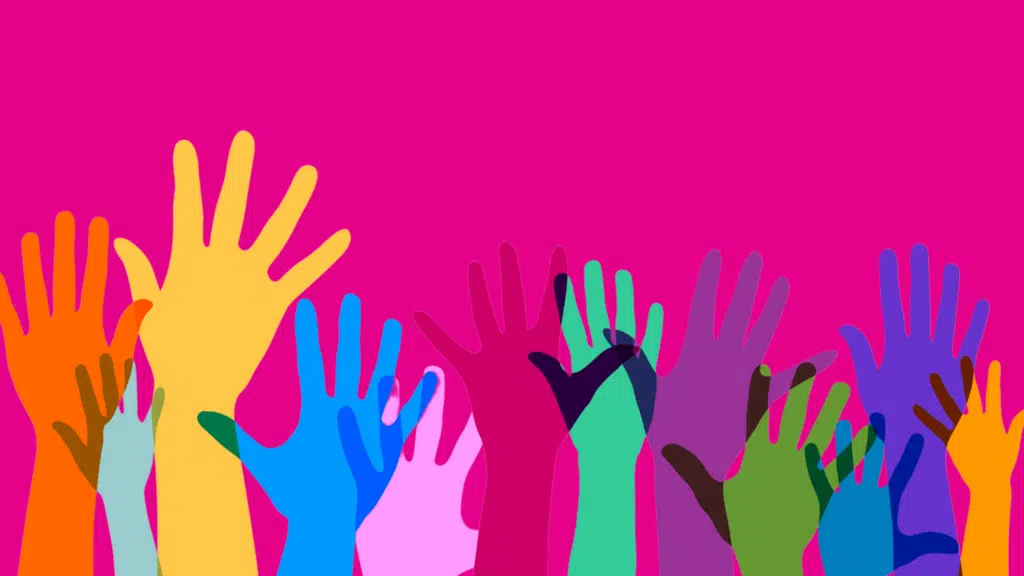 Colorful hands raised on a pink background